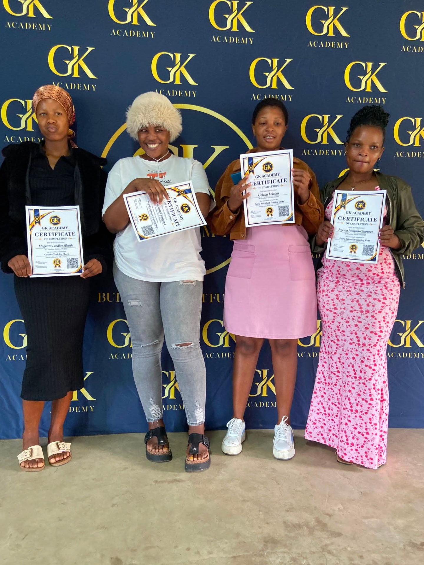 GK Academy graduates holding certificates